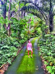 girl on road in rainforest