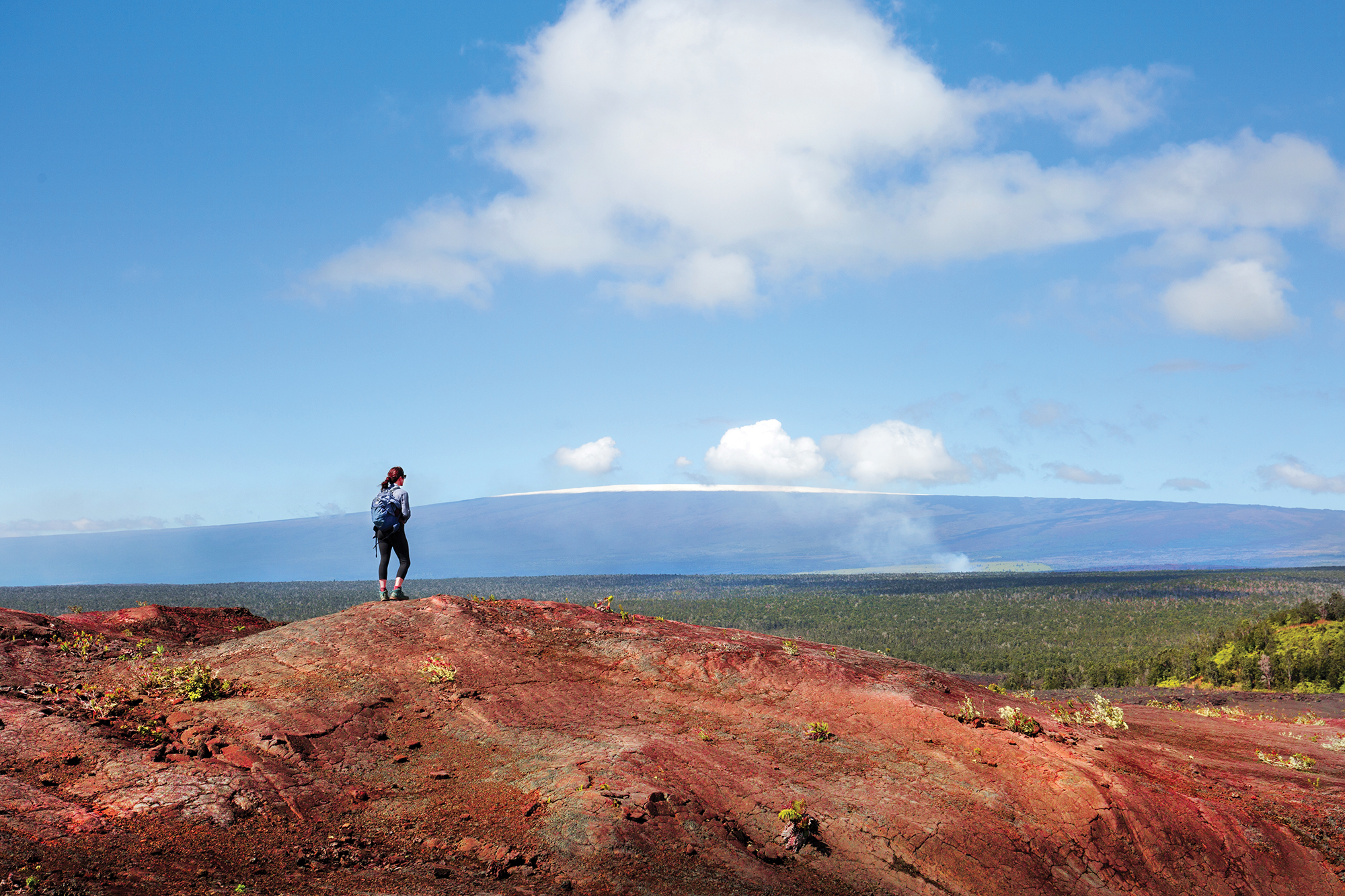 lone hiker with Hawai'i volcano landscape