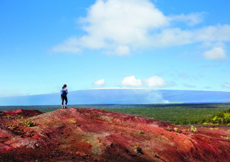 Solo woman hiker model in Hawaiʻi trekking across the Volcano National Park landscape on solid lava rock
